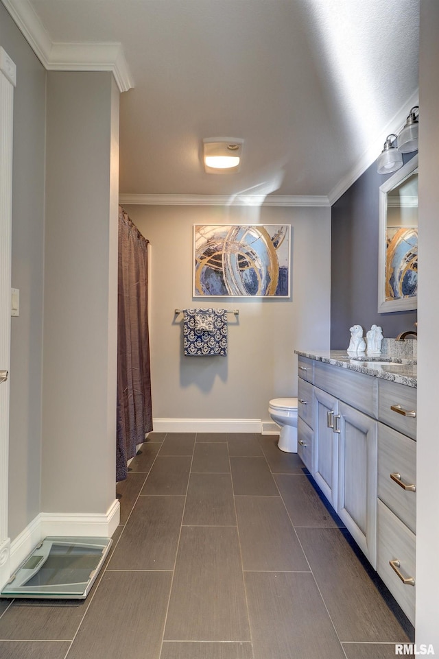 bathroom featuring vanity, toilet, and ornamental molding