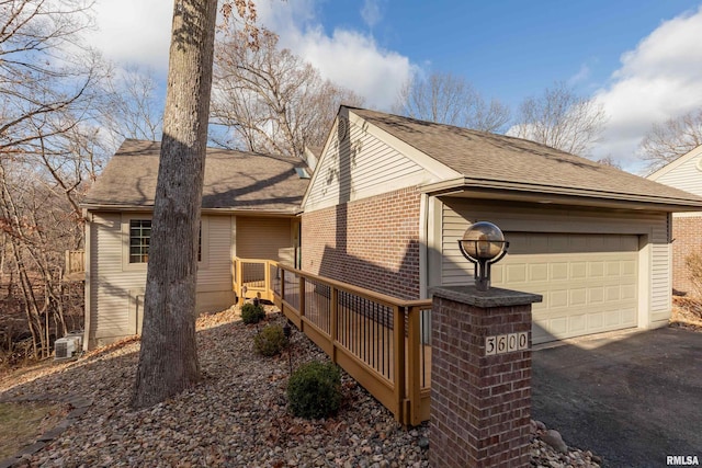 view of property exterior featuring central air condition unit, a deck, and a garage