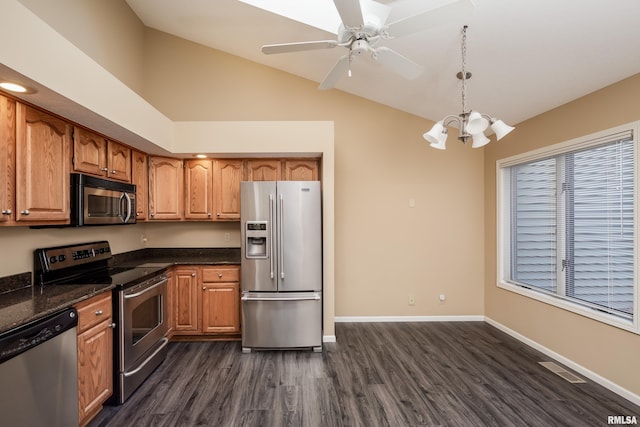 kitchen with ceiling fan with notable chandelier, stainless steel appliances, decorative light fixtures, high vaulted ceiling, and dark hardwood / wood-style floors