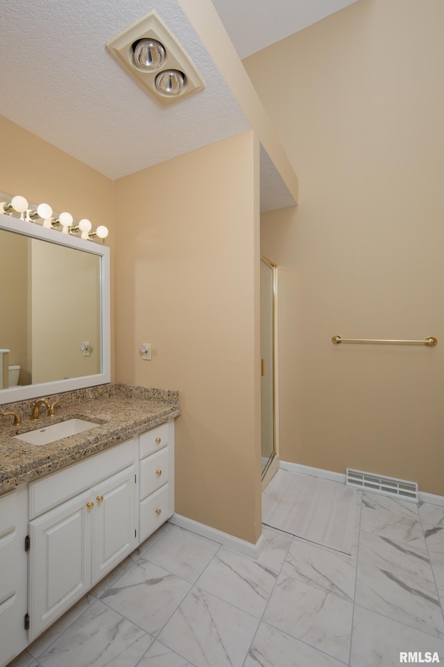 bathroom with vanity and an enclosed shower