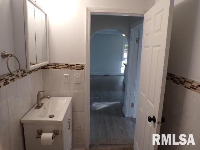 bathroom with vanity, tile walls, and hardwood / wood-style flooring