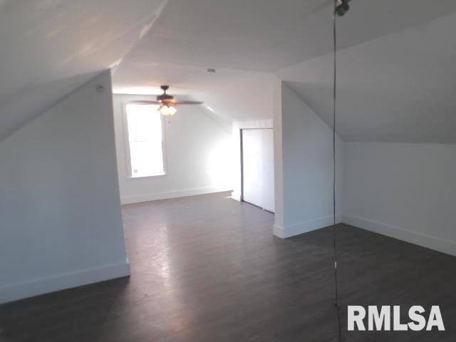 bonus room with dark hardwood / wood-style floors, vaulted ceiling, and ceiling fan