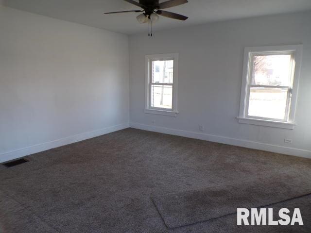 carpeted empty room featuring ceiling fan and a healthy amount of sunlight