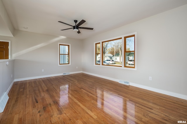 spare room with ceiling fan and wood-type flooring