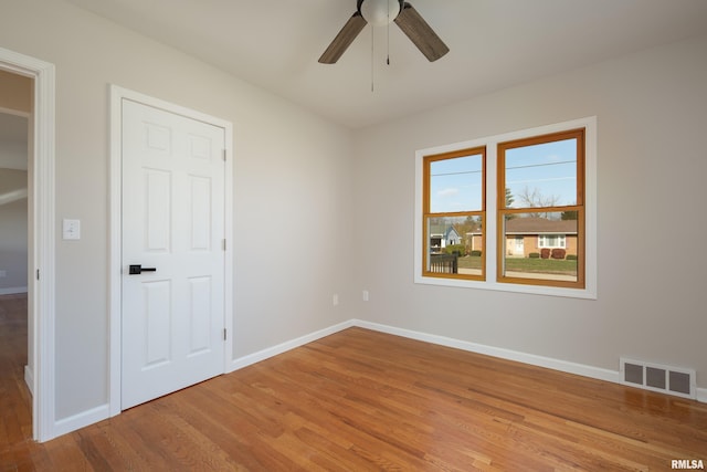 spare room featuring hardwood / wood-style floors and ceiling fan