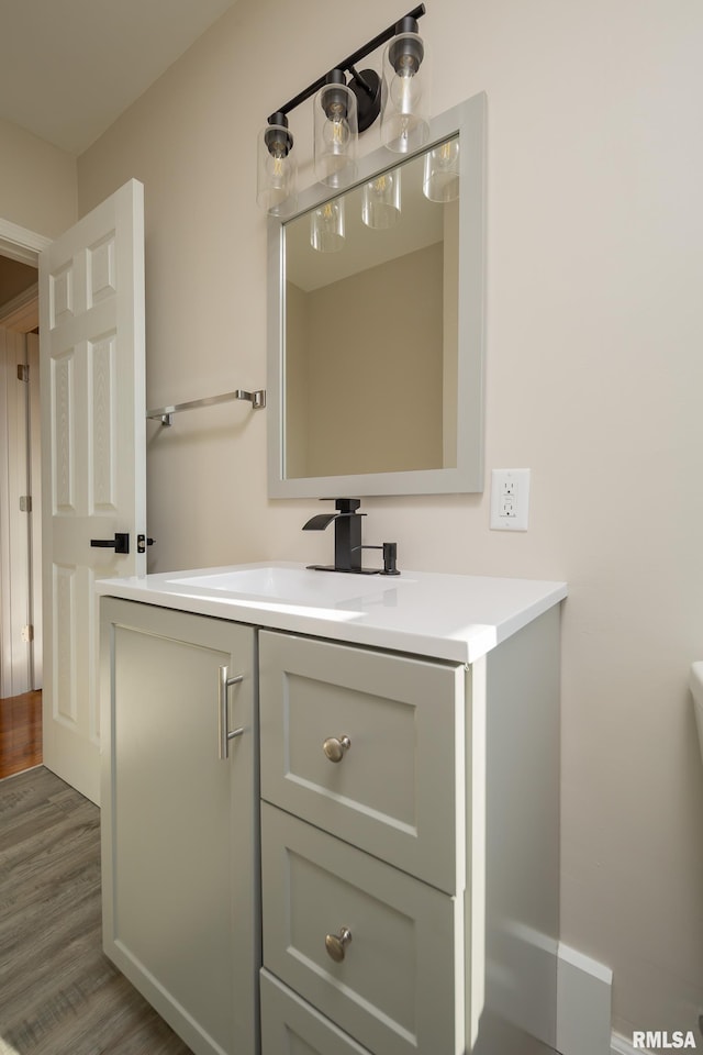 bathroom with vanity and wood-type flooring