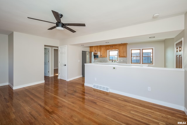 interior space with hardwood / wood-style floors, ceiling fan, and sink