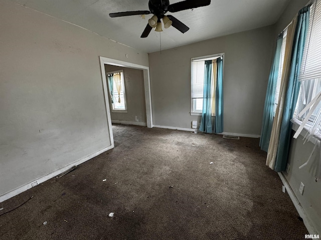 carpeted empty room featuring ceiling fan