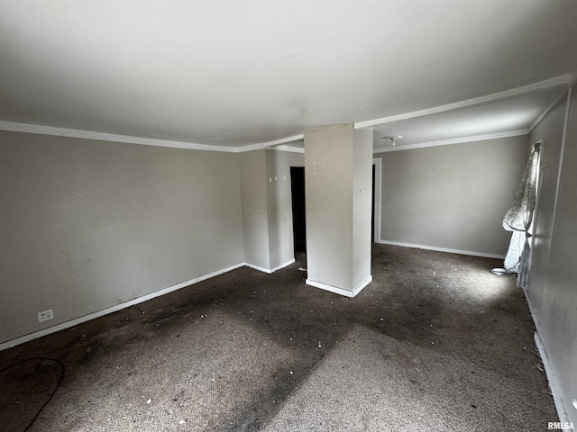 empty room with dark carpet and ornamental molding