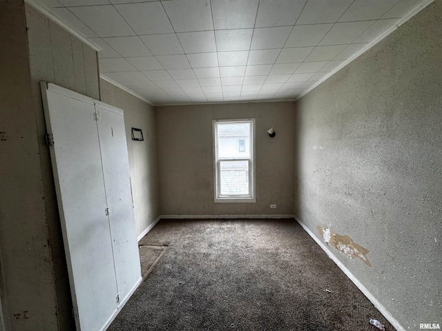 unfurnished bedroom featuring carpet floors and crown molding