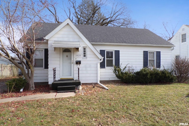 bungalow-style home with a front lawn