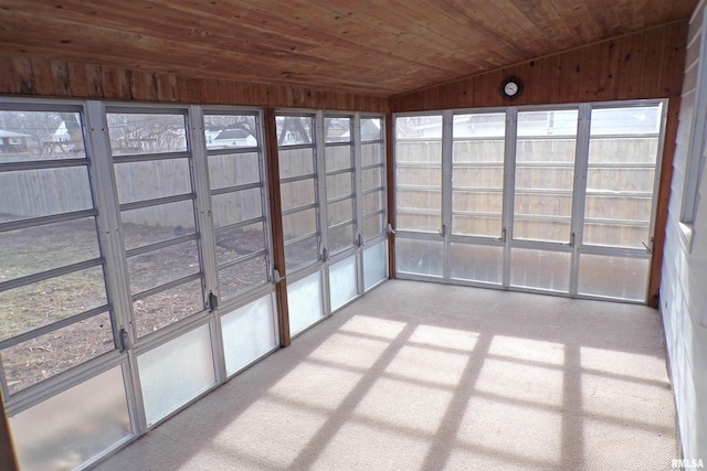 unfurnished sunroom featuring wooden ceiling and vaulted ceiling