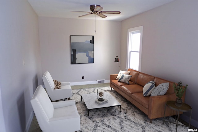 living room featuring ceiling fan and carpet