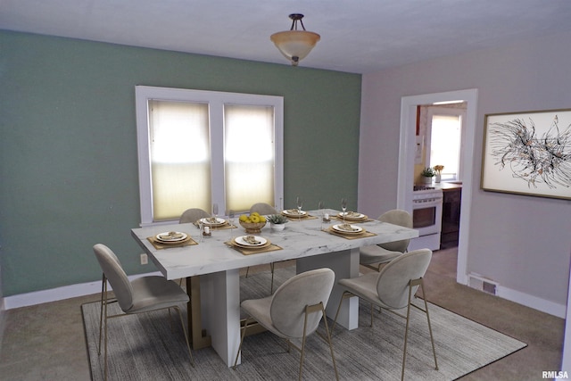 view of carpeted dining space