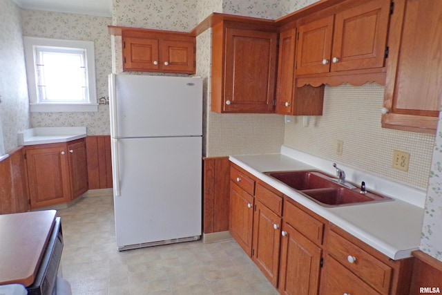 kitchen featuring white fridge and sink