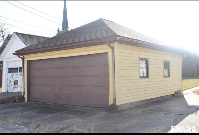 view of home's exterior featuring a garage and an outbuilding