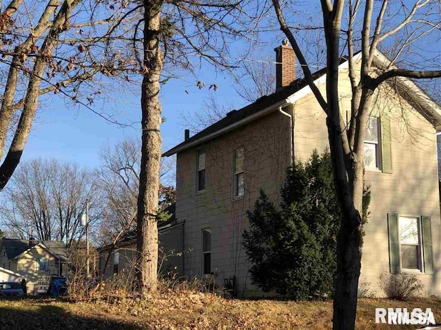 2307 Farnam St, Davenport, IA 52803 - view of home's exterior with a chimney