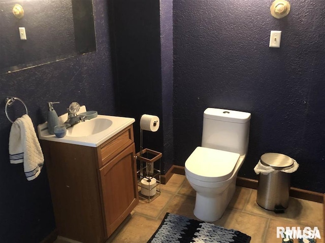 bathroom featuring tile patterned floors, vanity, and toilet