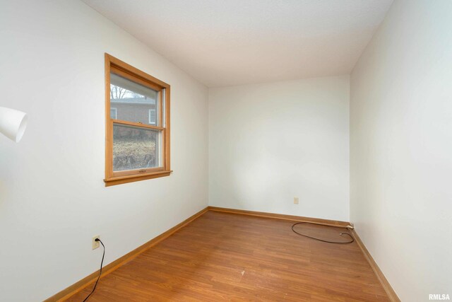 unfurnished room featuring wood finished floors and baseboards