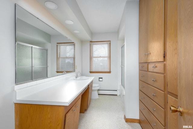 full bathroom featuring toilet, vanity, and a baseboard radiator