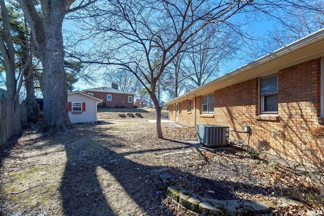 view of yard with cooling unit and fence