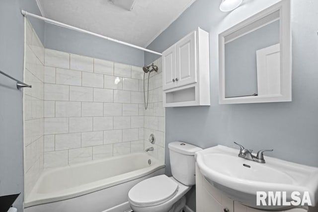 full bathroom with vanity, tiled shower / bath, and toilet