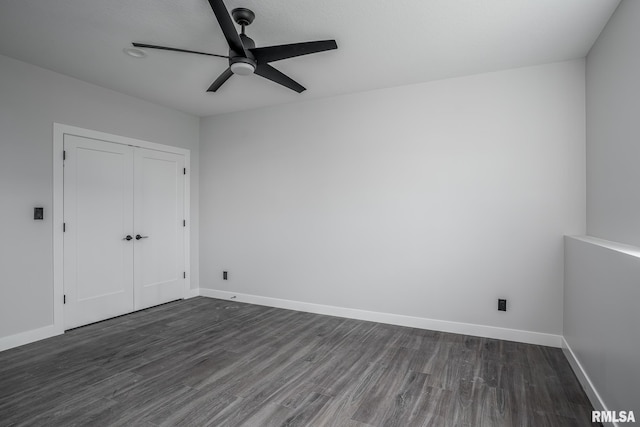 1915 E 59th Ct, Davenport, IA 52807 - unfurnished bedroom with dark wood-style floors, a closet, and a ceiling fan