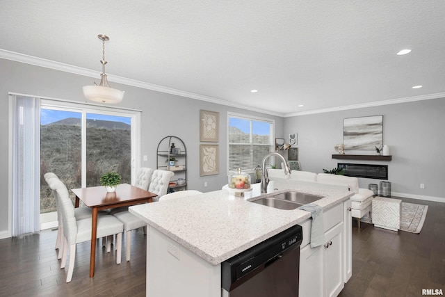 kitchen featuring pendant lighting, white cabinets, a center island with sink, sink, and stainless steel dishwasher