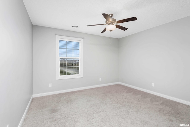 spare room with carpet flooring and ceiling fan