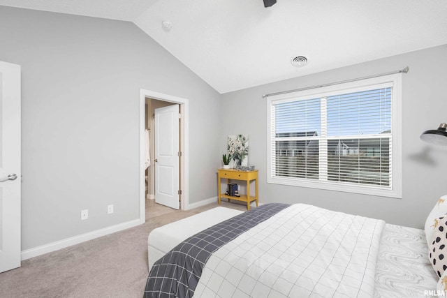 carpeted bedroom with vaulted ceiling