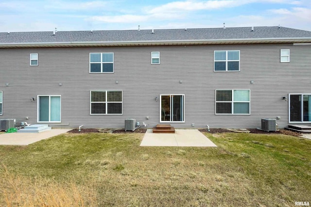 rear view of house with a patio, central AC unit, and a lawn