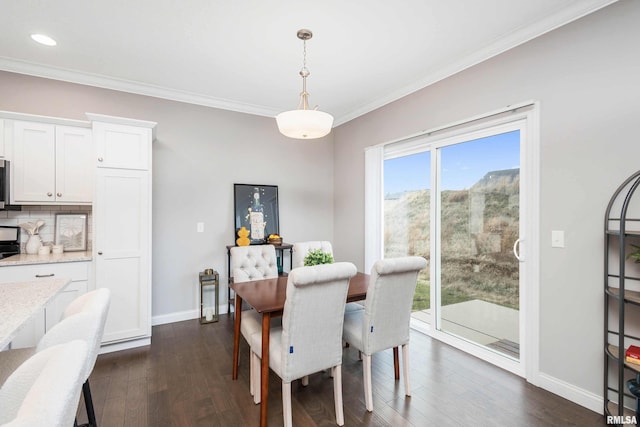 dining room with dark hardwood / wood-style flooring and ornamental molding