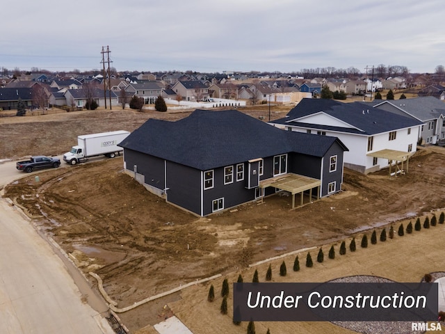 birds eye view of property with a residential view