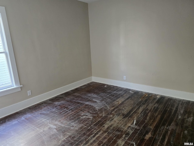 unfurnished room with dark hardwood / wood-style flooring