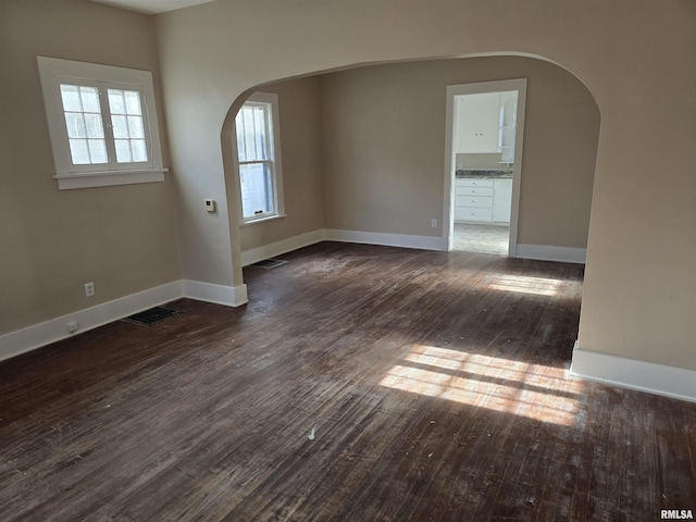 unfurnished room featuring dark wood-type flooring