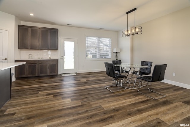 dining space featuring dark hardwood / wood-style flooring and sink