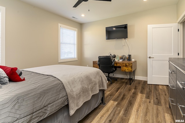 bedroom with ceiling fan and dark hardwood / wood-style flooring