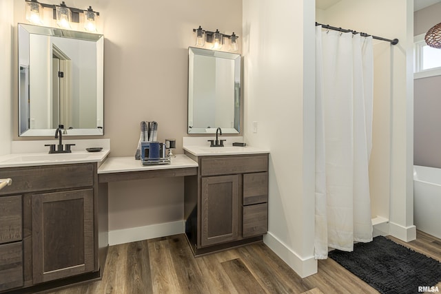 bathroom featuring vanity, wood-type flooring, and walk in shower