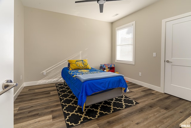 bedroom with ceiling fan and dark hardwood / wood-style floors