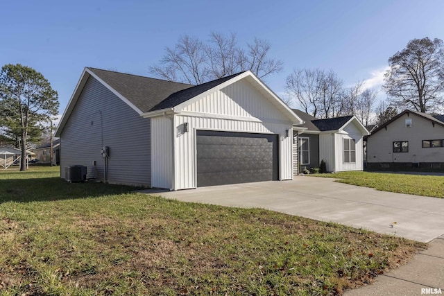 view of front of home with central AC unit, a garage, and a front yard