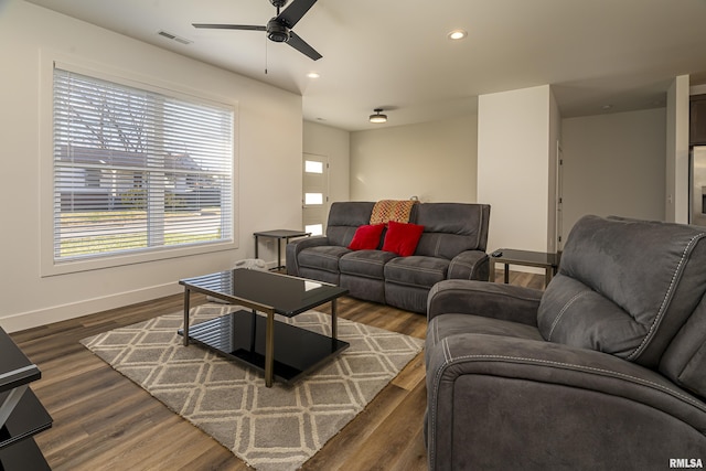 living room with ceiling fan and dark hardwood / wood-style flooring