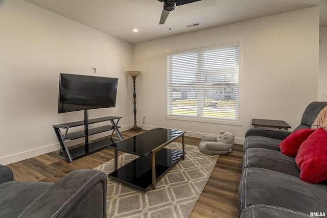 living room with ceiling fan and dark hardwood / wood-style flooring