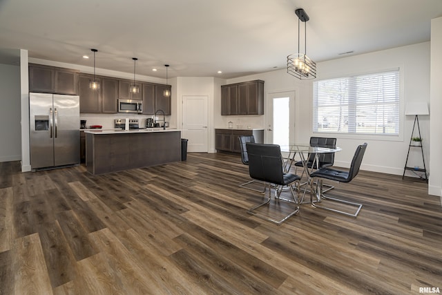 dining area with dark wood-type flooring and sink