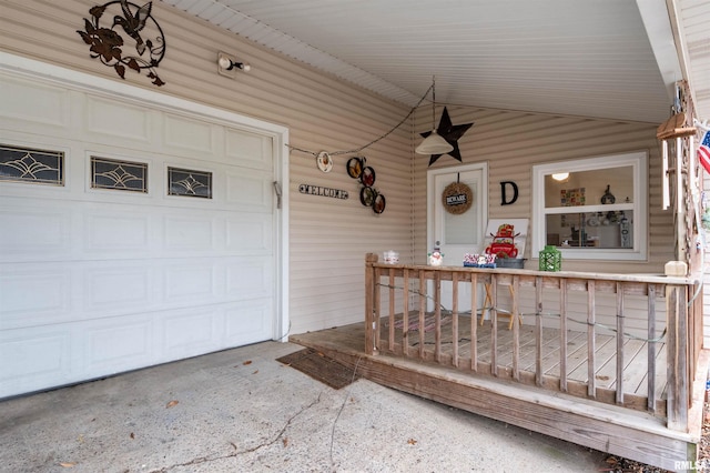 doorway to property featuring a porch and a garage