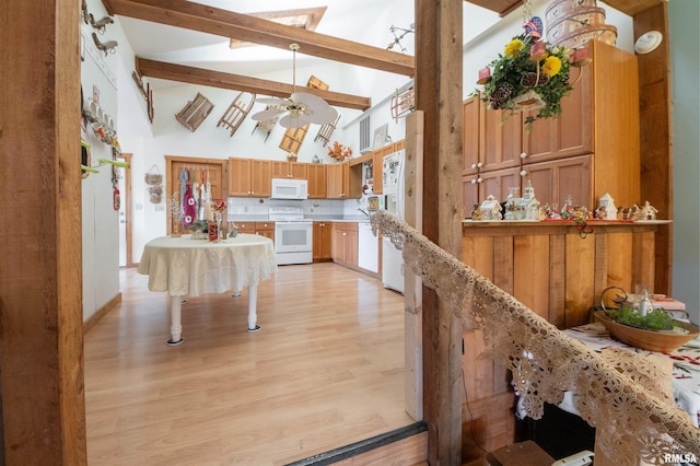 interior space featuring beamed ceiling, high vaulted ceiling, white appliances, light wood finished floors, and light countertops