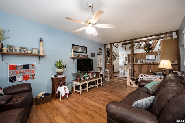 living area featuring a ceiling fan and light wood-style floors