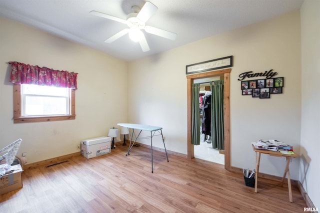 miscellaneous room with wood finished floors, baseboards, and ceiling fan