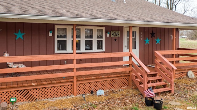 property entrance featuring board and batten siding and a shingled roof