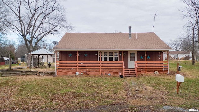 view of front of home with a porch, board and batten siding, a front lawn, and a shingled roof