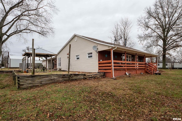 rear view of property with a gazebo and a lawn